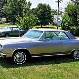 Our 1965 Evening Orchid Malibu SS L79 4 speed. In the background our 1967 Chevelle 2dr 300 Deluxe with her original 283 engine