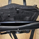 Supple leather computer “Briefcase” with pockets for credit cards, pens, cords, datebook and more. Holds my laptop and iPad easily. The outer two compartments have strong magnetic snaps. It has an over the shoulder strap as well.
